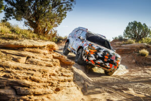 2026 Honda Passport in camouflage, descending rocky hill. Image courtesy of Honda